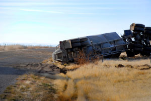 Car wreck of semi truck trailer rolled over