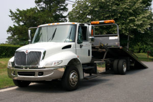 white flatbed tow truck