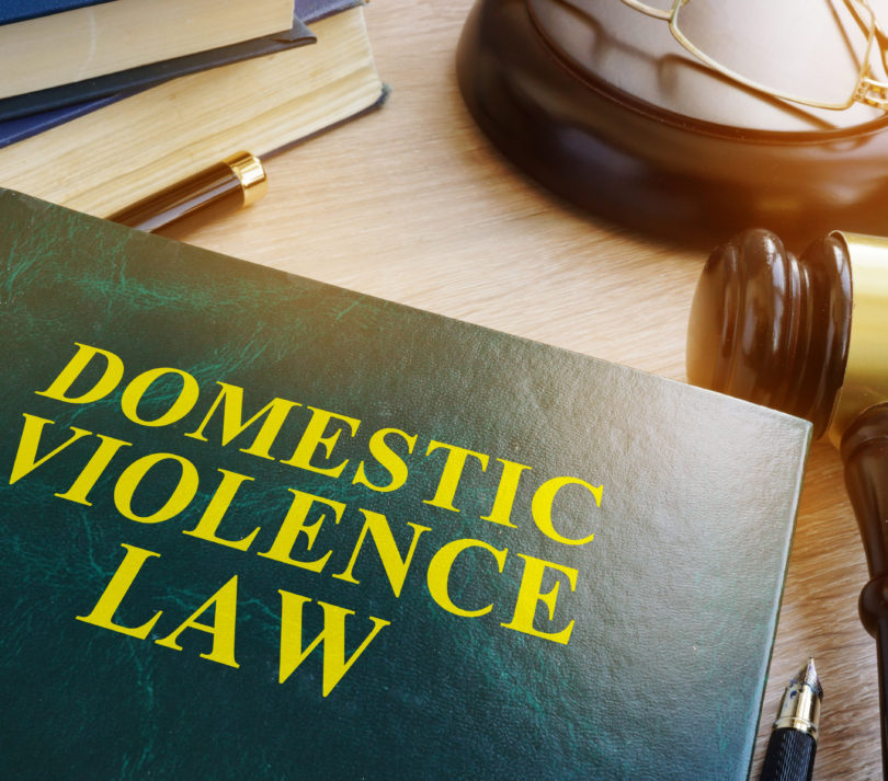 domestic violence law on wooden table
