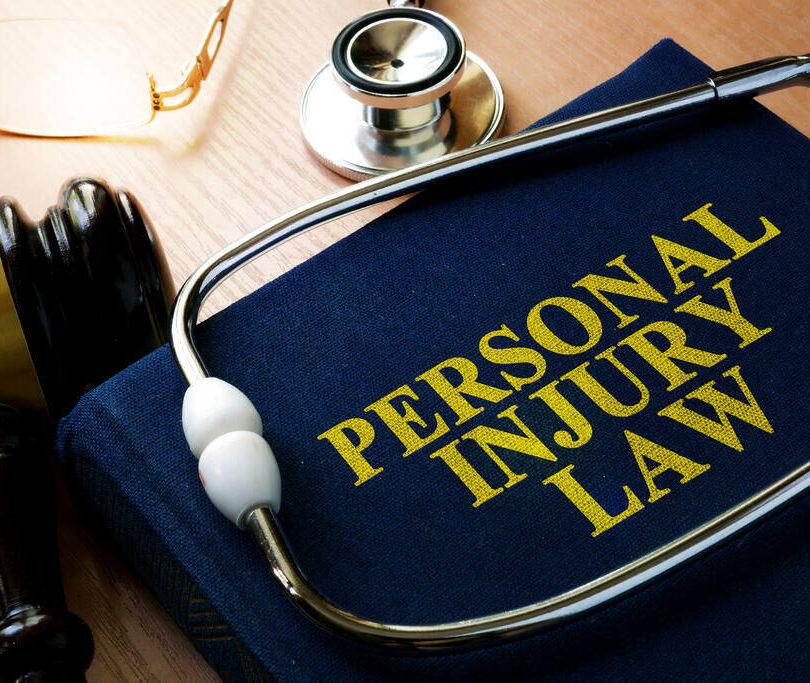 Personal injury law book, stethoscope and gavel